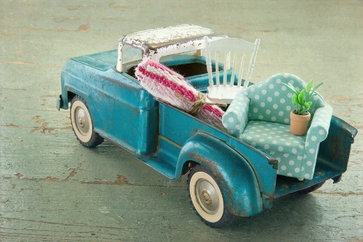 Old vintage toy truck packed with furniture.